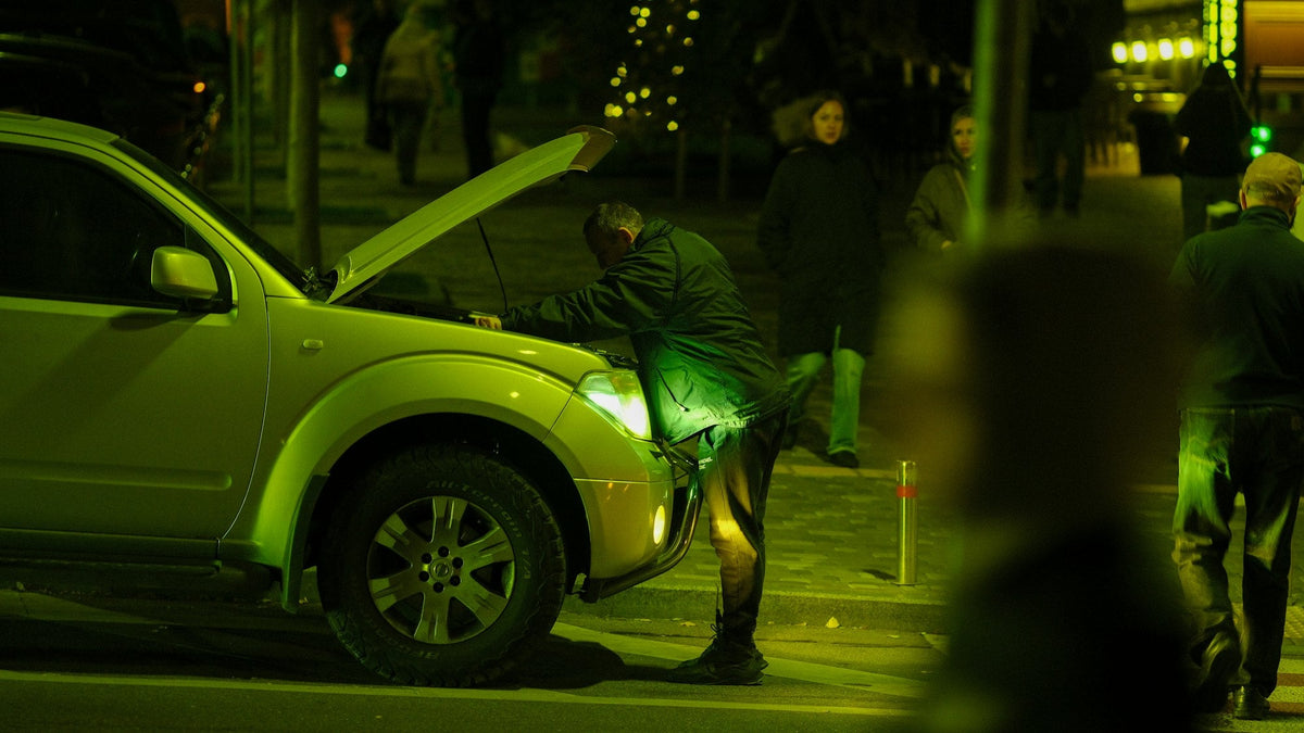 Checking a car engine at night