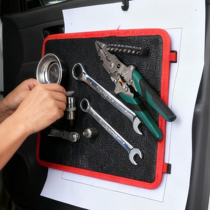 Magnetic tool pad holding spanners and pliers on a car door