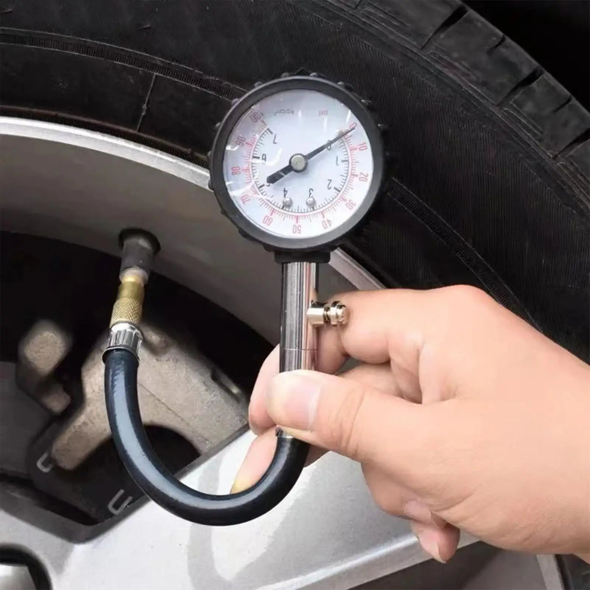 Checking car tire pressure with the gauge