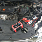 Battery charger connected to a car battery in the engine bay