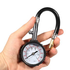 Tire pressure gauge held in hand