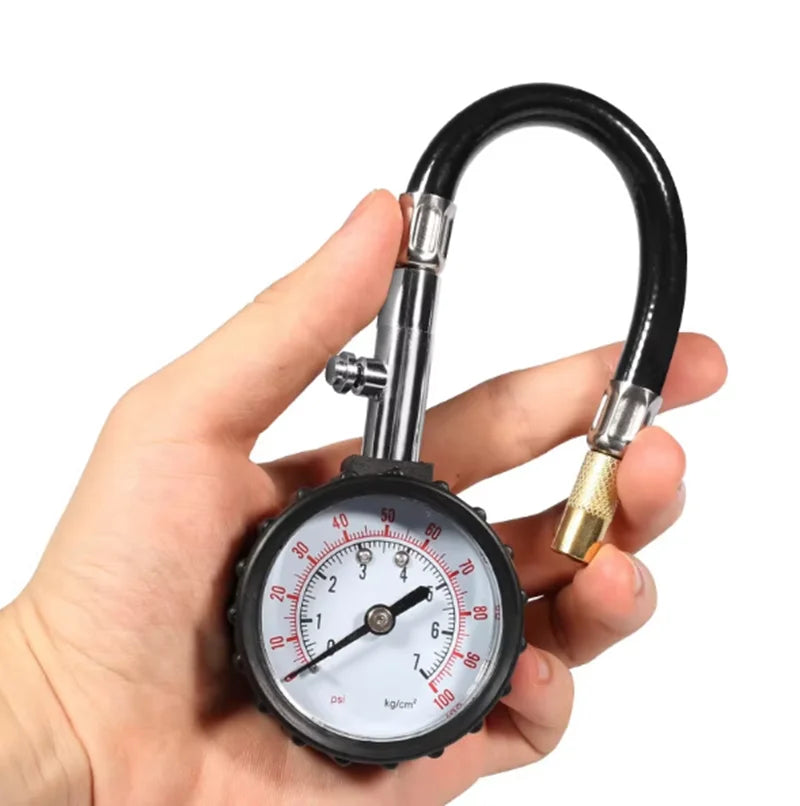 Tire pressure gauge held in hand